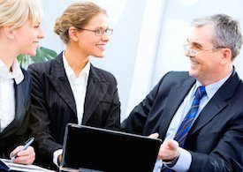 Three Business People Having a Sales Conversation with Laptop Computer